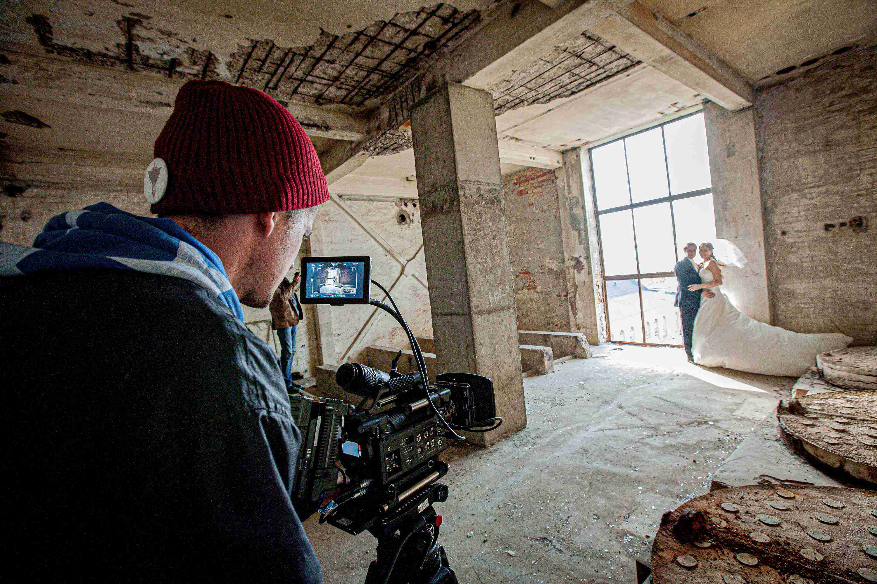 image of a cameraman filming a newlywed couple